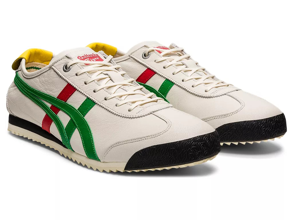 Pair of white sneakers with green, red, and black accents on a white background